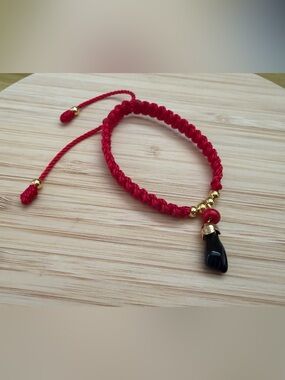 Azabache Red Braided Cord Bracelet with Black Pendant and Gold Accents